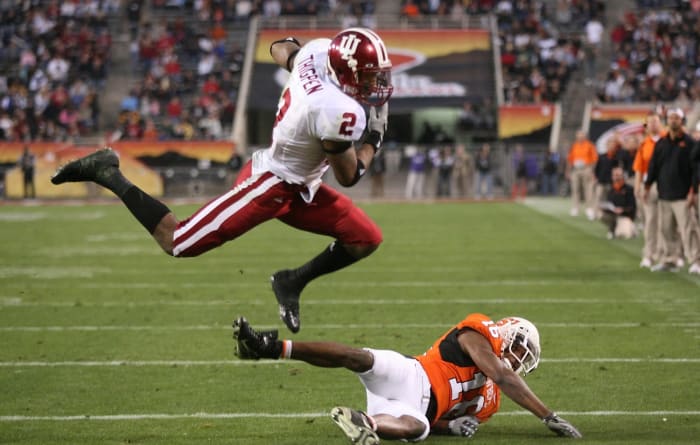Indiana Hoosiers running back Marcus Thigpen leaps over Oklahoma State Cowboys defensive back Perrish Cox (16) during the second quarter